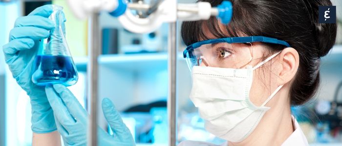 pharmacist looking at a tube of chemicals